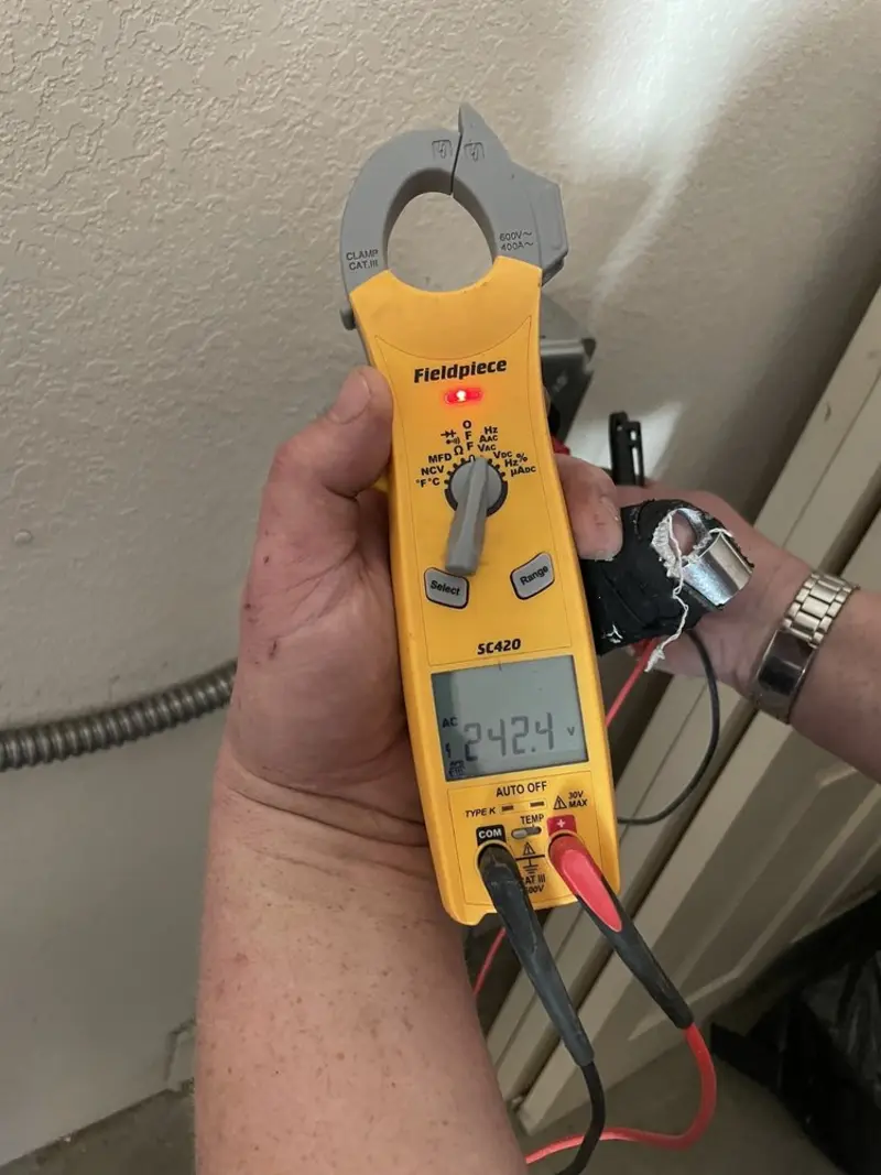 Voltage testing with clamp meter during Recessed Lighting Installation in Mount Kisco